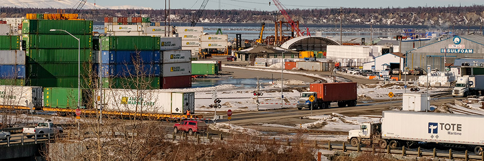 photo of container storage, businesses, cranes, and trucks in the project area